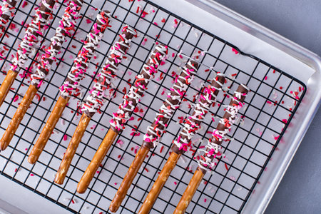 Valentines day treat, chocolate covered pretzel rods with sprinklesの写真素材