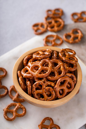 Mini pretzels in a wooden bowl, salty snackの写真素材