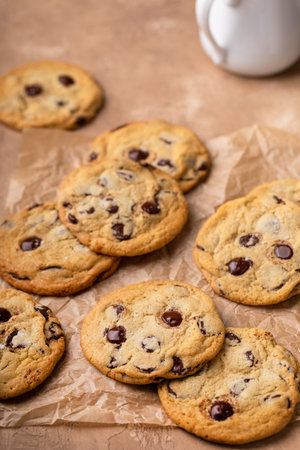 Chocolate chip cookies with flaky salt on parchment paperの写真素材