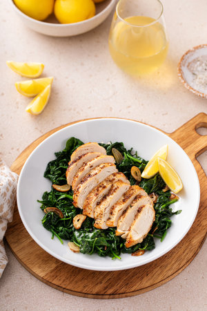Grilled chicken with sauteed spinach and lemon, healthy dinner ideaの写真素材