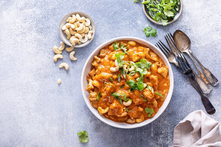 Traditional red thai chicken curry with cashews and herbs, overhead viewの写真素材
