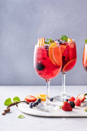 Refreshing summer berry sangria with red wine, apples and orangesの写真素材