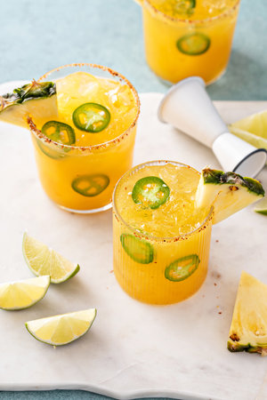 Pineapple jalapeno margarita cocktail in glasses with tajin rimの写真素材
