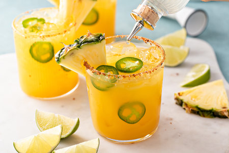 Pineapple jalapeno margarita cocktail in glasses with tajin rimの写真素材