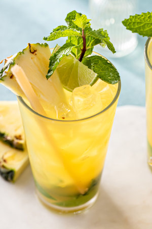Pineapple mojito with limes and mint and a slice of pineappleの写真素材