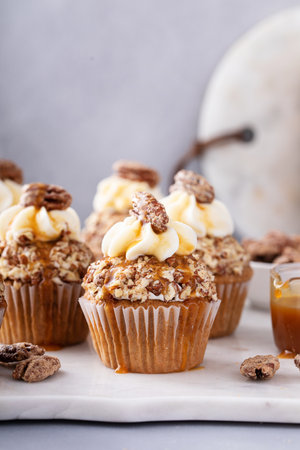 Pumpkin spice caramel pecan cupcakes with cream cheese frostingの写真素材