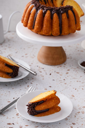 Orange pound bundt cake with dark chocolate ganache and chocolate sprinkles