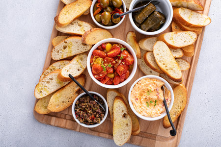 Snack board with toasted baguette and variety of dips and appetizersの写真素材