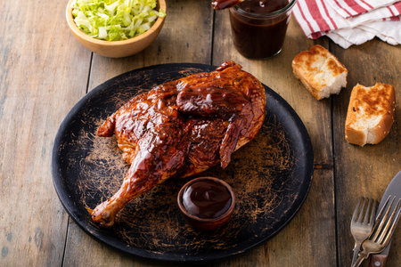 Barbeque smoked half chicken served with bbq sauce, salad and toastの写真素材