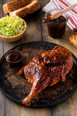 Barbeque smoked half chicken served with bbq sauce, salad and toastの写真素材
