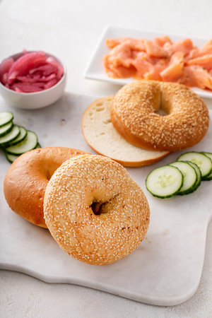 Freshly baked bagels served with dill cream cheese, salmon and cucumbersの写真素材