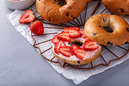 Variety of bagels served with strawberry cream chees and fresh strawberriesの写真素材
