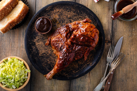 Barbeque smoked half chicken served with bbq sauce, salad and toastの写真素材