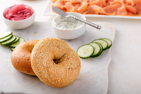 Freshly baked bagels served with dill cream cheese, salmon and cucumbersの写真素材
