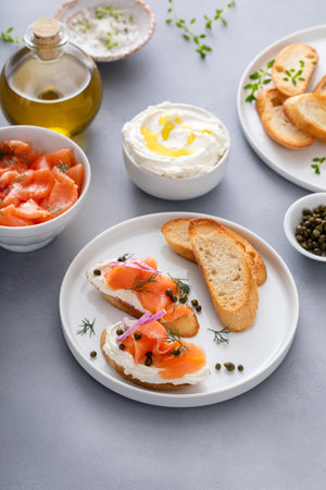 Salmon and cream cheese bruschetta with fresh dill and capersの写真素材