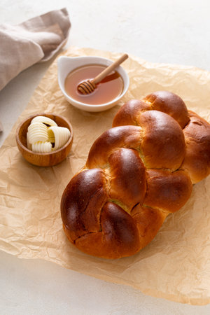 Freshly baked hallah served with butter and honeyの写真素材