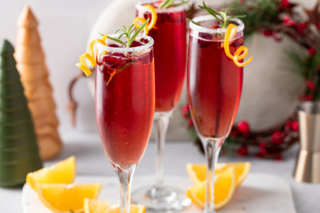 Festive Christmas mimosa cocktail with cranberry juice and orange zest garnishの写真素材