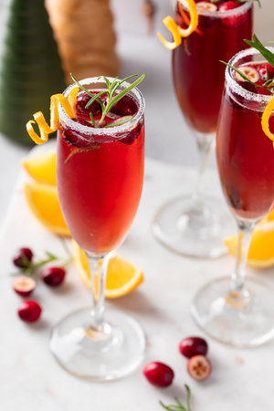 Festive Christmas mimosa cocktail with cranberry juice and orange zest garnishの写真素材