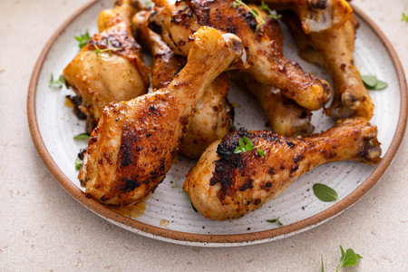 Roasted chicken drumsticks with garlic and herbsの写真素材
