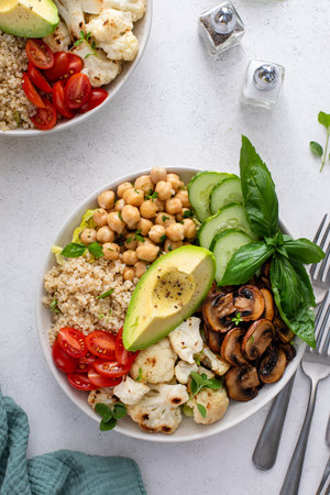 Healthy high protein vegan plant based lunch bowl with mushrooms, roasted cauliflower, chickpeas and quinoaの写真素材