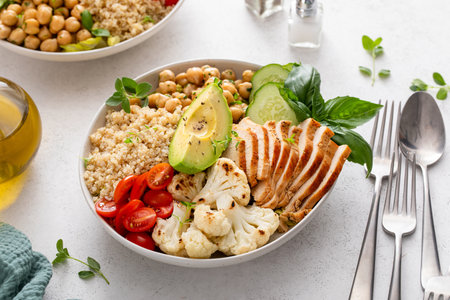 Healthy high protein lunch bowl with grilled chicken, roasted cauliflower, chickpeas and quinoaの写真素材