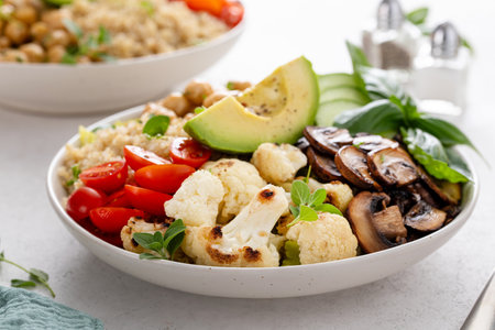 Healthy high protein vegan plant based lunch bowl with mushrooms, roasted cauliflower, chickpeas and quinoaの写真素材