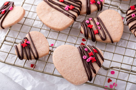 Heart shaped cookies with strawberry flavor, drizzled with dark chocolateの写真素材