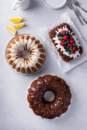 Variety of homemade bundt cakes and loaf cakes ready to eat overhead viewの写真素材