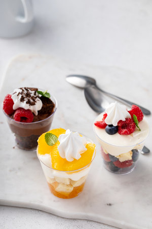 Variety of dessert in cups, individual desserts in cups for cateringの写真素材