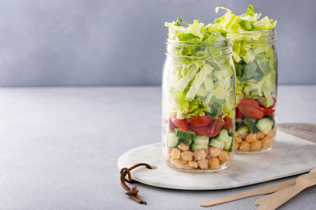 Meal prep for lunch, healthy salad in a jar with fresh vegetables and chickpeasの写真素材