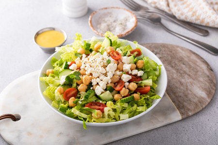 Healthy salad for lunch with fresh vegetables, chickpeas and feta in a bowlの写真素材