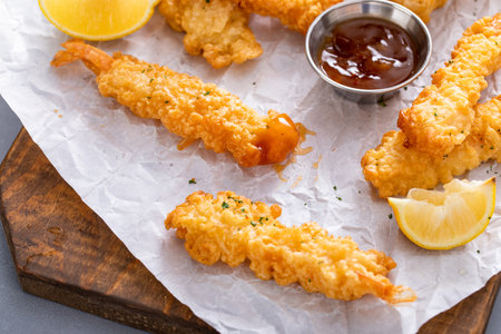 Cooked tempura shrimp on a serving board with dipping sauce freshly made and ready to eatの写真素材