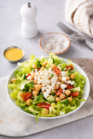 Healthy salad for lunch with fresh vegetables, chickpeas and feta in a bowlの写真素材