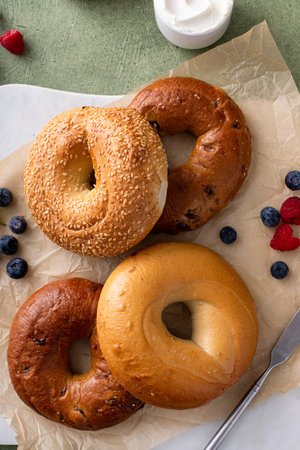Variety of bagels freshly baked for breakfast ready to eat, plain, sesame seed and cinnamon raisin bagelsの写真素材