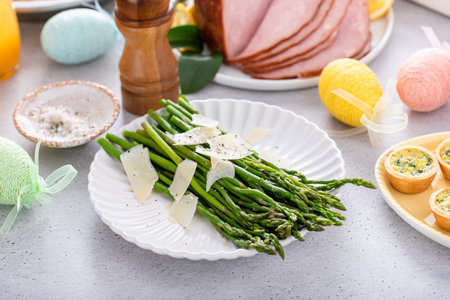 Cooked asparagus served with shaved parmesan for Easter brunchの写真素材