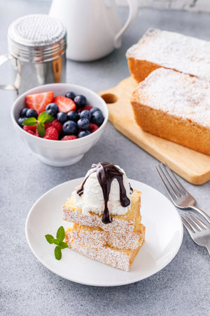 Traditional vanilla pound cake sliced and served with ice cream and fresh berriesの写真素材