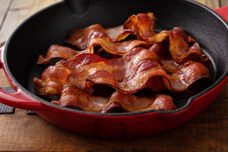 Cooked bacon in a cast iron skillet ready to eat for breakfastの写真素材