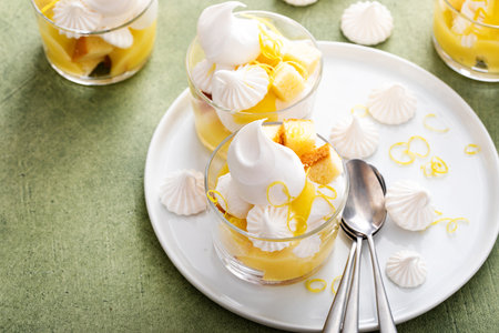 Lemon meringue parfait with pound cake, lemon mousse, whipped cream and meringue kissesの写真素材