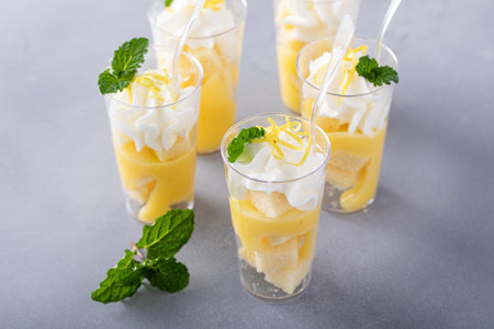 Lemon meringue trifles in a cup with pound cake, lemon curd and whipped creamの写真素材