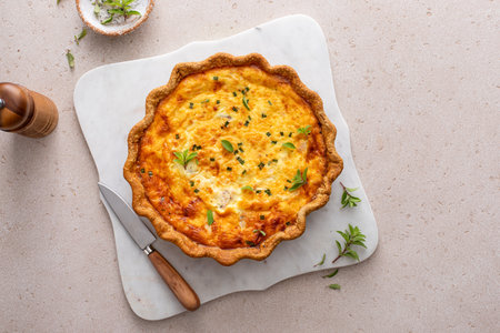 Salmon and cheese quiche with herbs freshly baked for breakfast, whole pieの写真素材