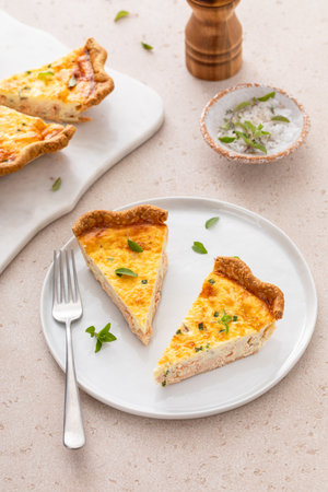 Salmon and cheese quiche with herbs freshly baked for breakfast cut into slicesの写真素材