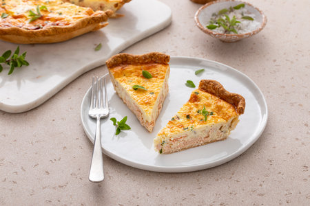 Salmon and cheese quiche with herbs freshly baked for breakfast cut into slicesの写真素材