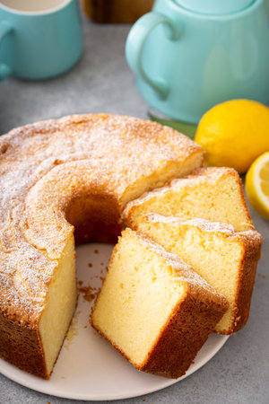 Lemon pound cake baked in a bundt pan sliced topped with powdered sugarの写真素材