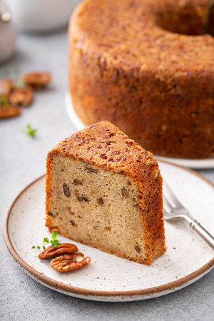 Pecan caramel pound cake baked in a bundt pan, homemade and slice served on a plateの写真素材