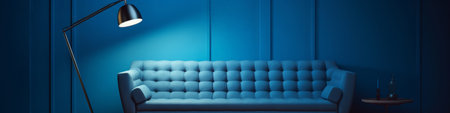 Stylish blue couch against a textured blue wall with chic decor and ambient lightingの素材