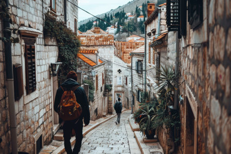 Young adventurer wanders through the charming, narrow lanes of a picturesque european old townの素材