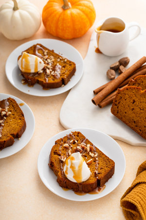 Pumpkin bread freshly baked topped with whipped cream, Thanksgiving dessertの写真素材