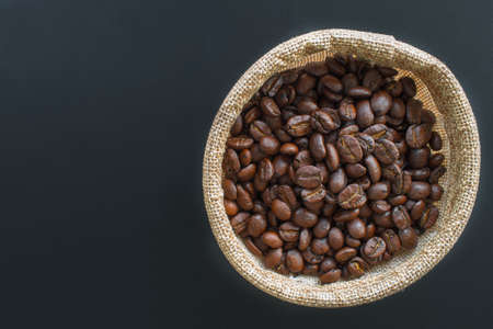 Coffee beans and coffee bags, isolated on black backgroundの写真素材