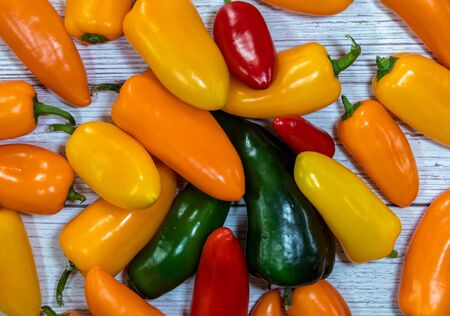 Group of whole fresh pepper flatlay on a wooden backgroundの写真素材