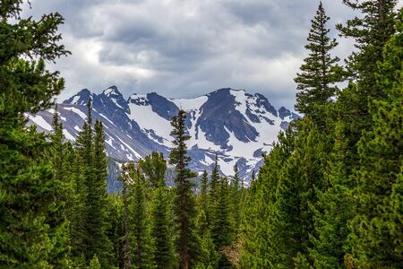 Dramatic forest and Indian Peaks near Red Rock Lake, Nederland, Colorado, on a spring dayの写真素材